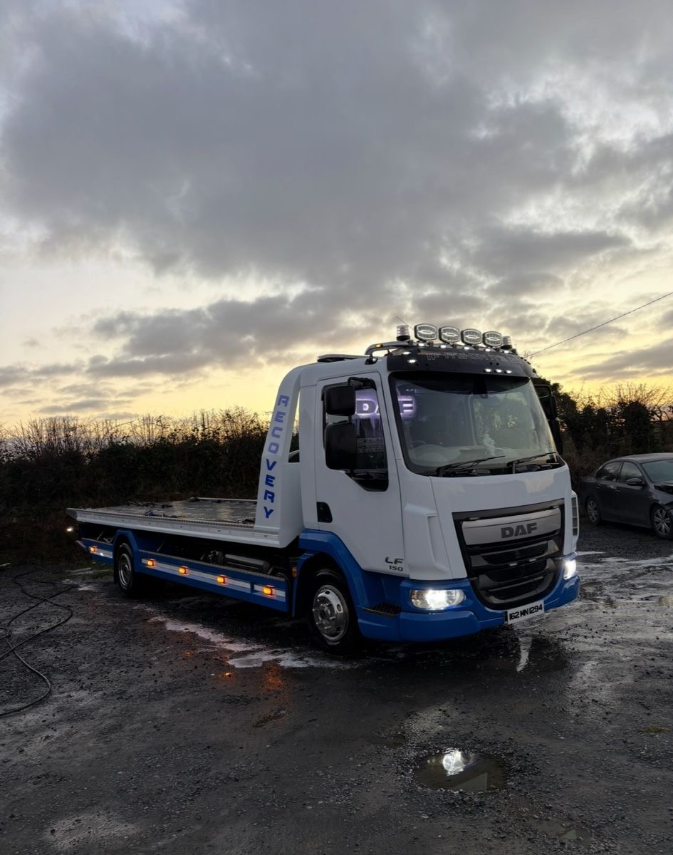 MD Recovery flatbed truck at dusk